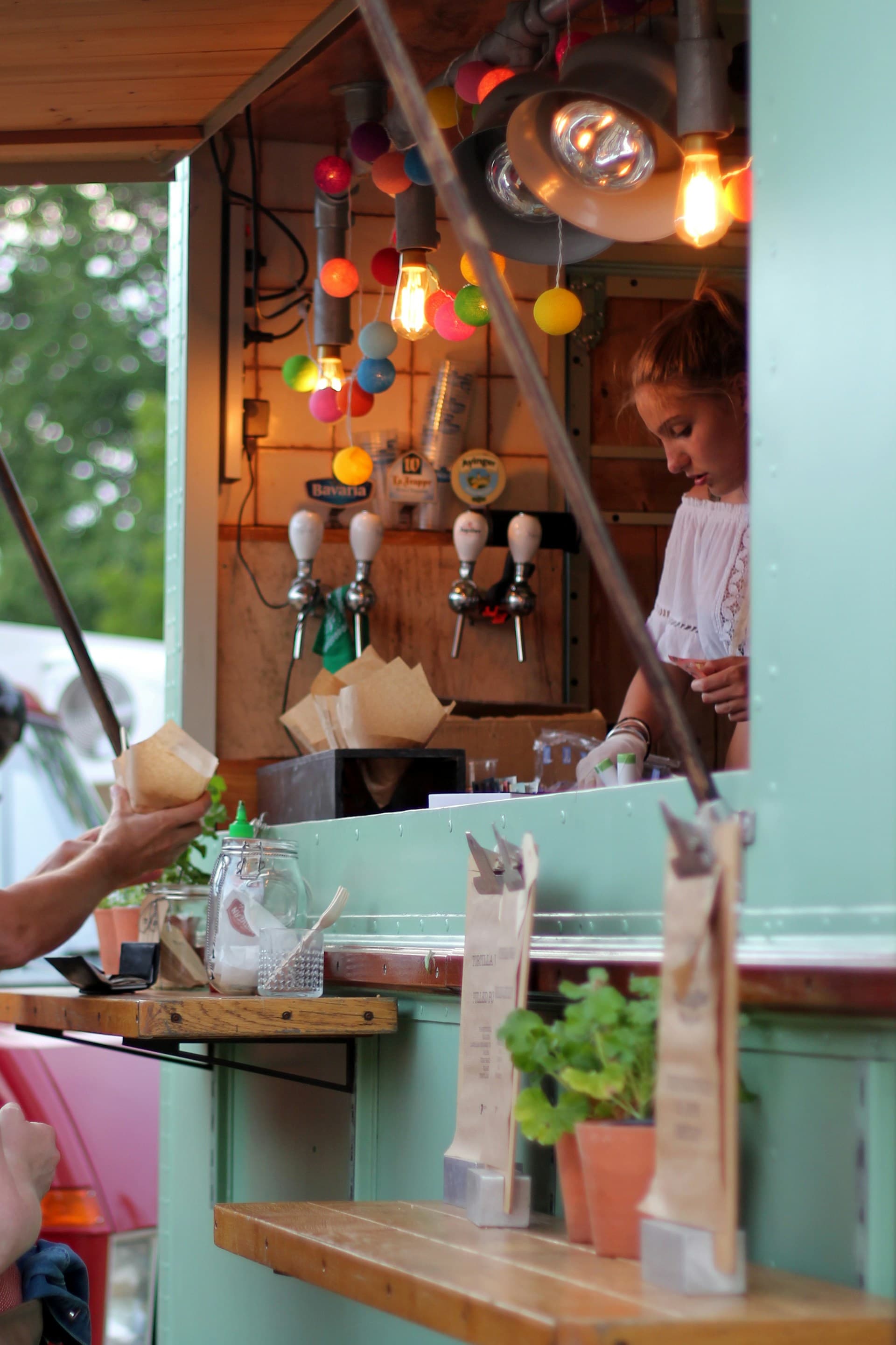 Food being plated in a food truck kitchen